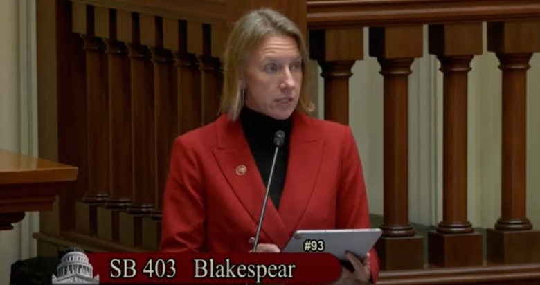 Video still of Senator Blakespear speaking at podium.