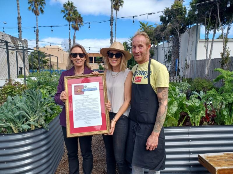 Sen. Catherine Blakespear, D-Encinitas, presents a Senate resolution to Jessica and Davin Waite, co-owners of The Plot restaurant, for being selected Senate District 38 Small Business of the Year.