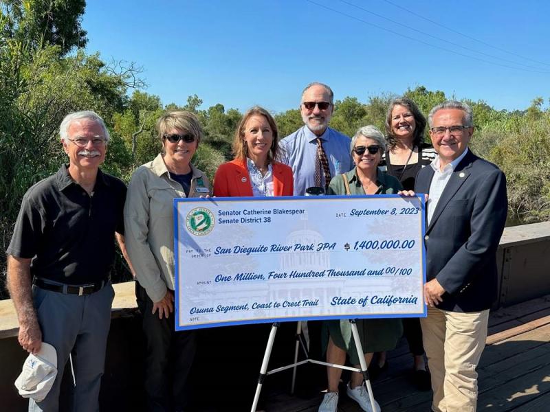 Sen. Blakespear presents check to the San Dieguito River Park JPA on Friday morning. 